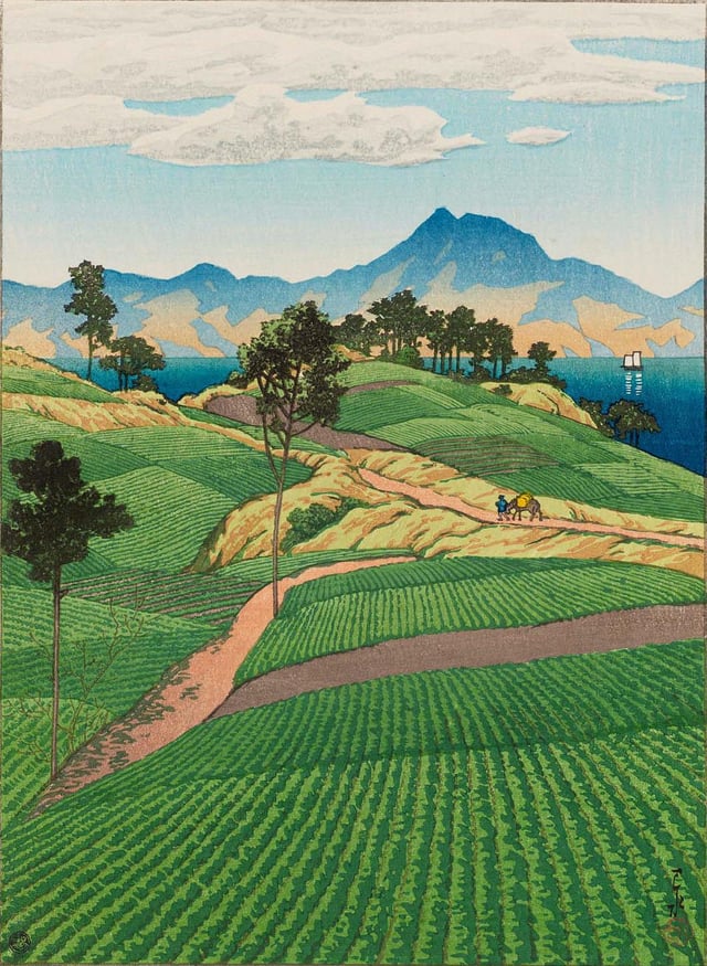 The scene depicts a series of rolling, terraced green fields in the foreground, meticulously detailed with rows of crops. A winding, reddish-tan dirt path snakes through the hills; a small figure of a traveler leading a pack horse is visible on the path in the middle distance.