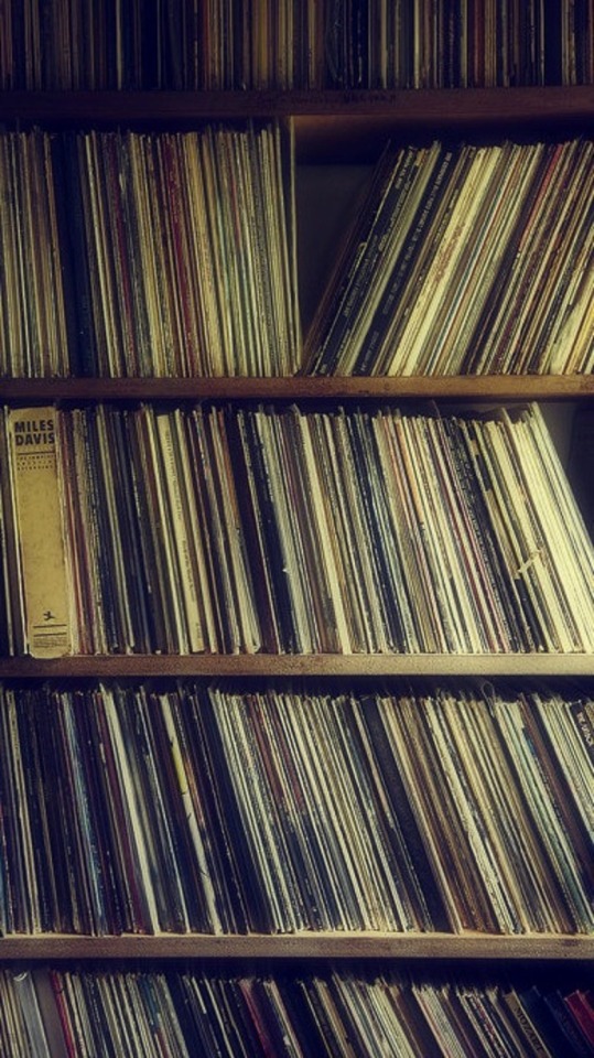 Shelves of old records, the photo itself looks old with a yellow light