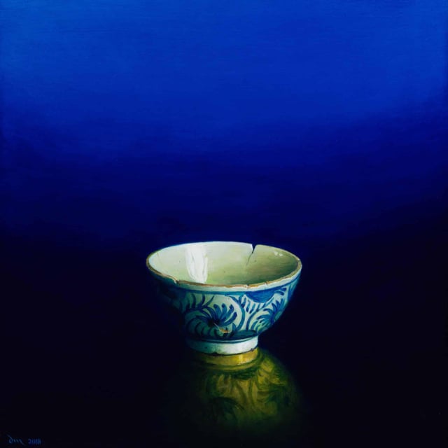 Painting of a cracked china bowl on a reflective surface and an intensely blue to black gradient background
