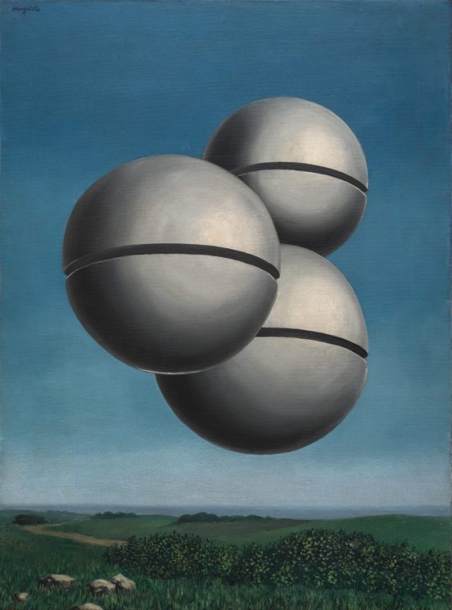 Three large, metallic silver spheres, each sliced horizontally by a dark central groove, hover together in a clear blue sky above a serene landscape of green hills.